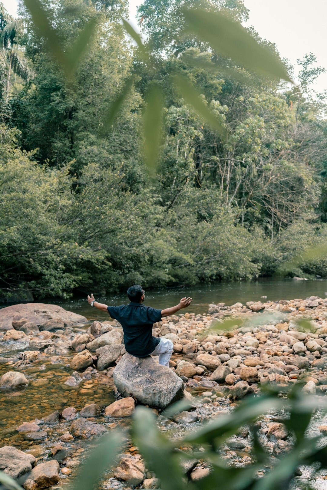 person meditating in serene landscape